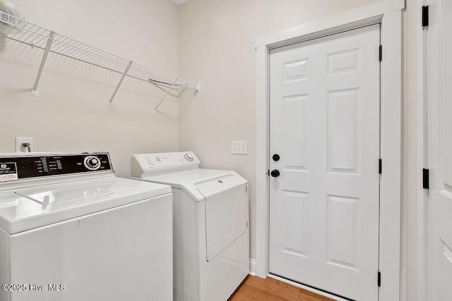 102 SW 8th St, Oak Island, NC 28465 - clothes washing area featuring laundry area, light wood finished floors, and washer and dryer