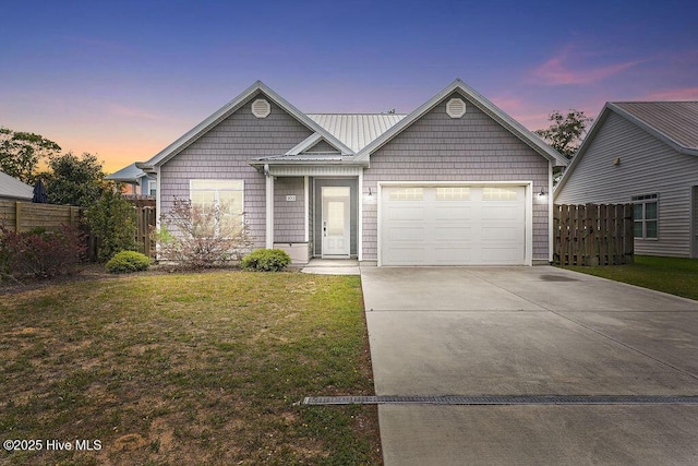 102 SW 8th St, Oak Island, NC 28465 - ranch-style home with fence, a yard, concrete driveway, and a garage