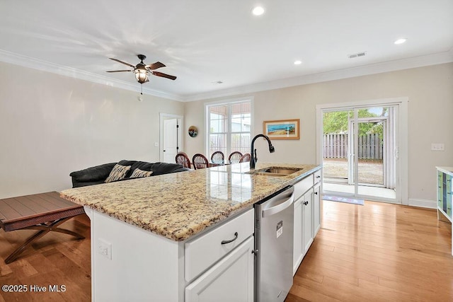 102 SW 8th St, Oak Island, NC 28465 - kitchen featuring a ceiling fan, stainless steel dishwasher, a sink, ornamental molding, and light wood-style flooring