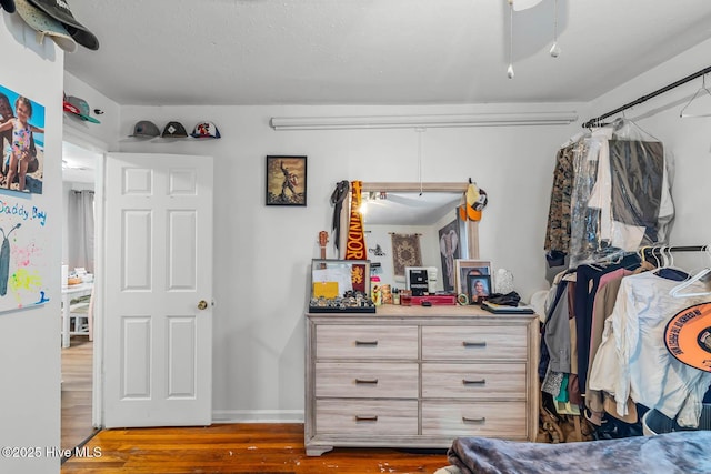 bedroom featuring baseboards and wood finished floors