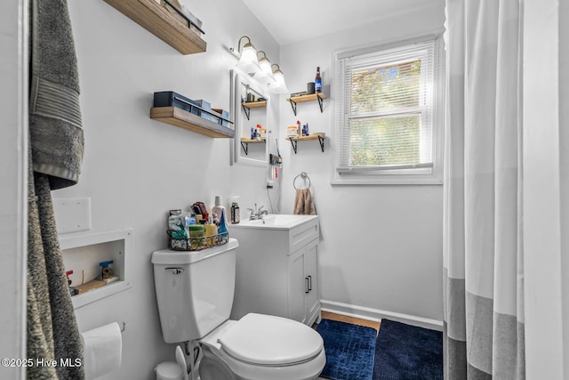 full bathroom with vanity, baseboards, wood finished floors, and toilet