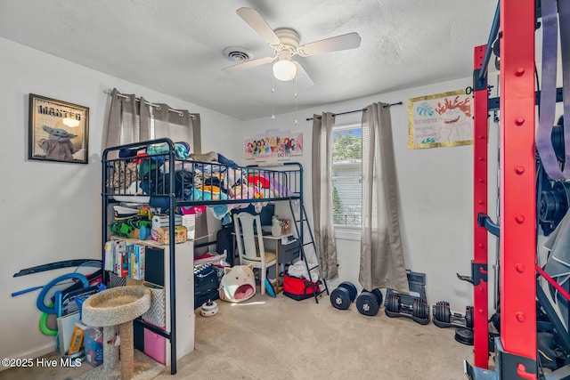 bedroom with carpet floors, ceiling fan, a textured ceiling, and visible vents