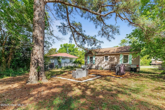 back of house featuring fence and a deck
