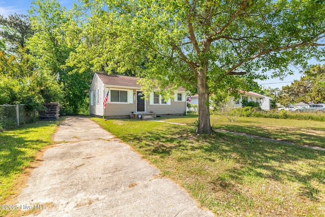 view of front of home with crawl space, driveway, fence, and a front lawn