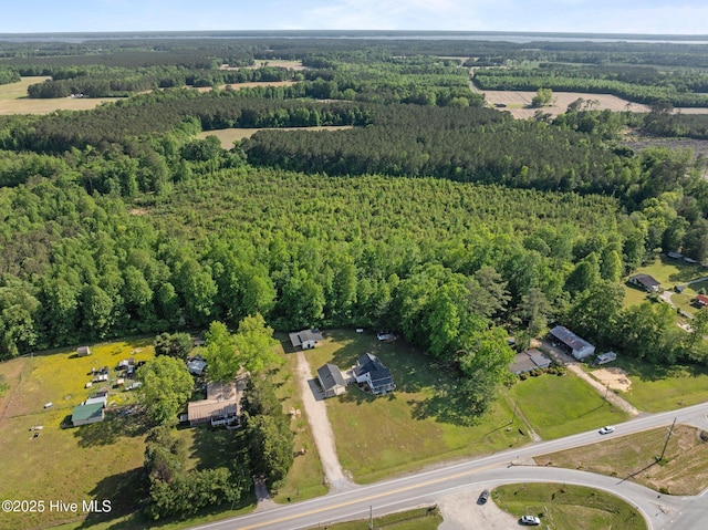 birds eye view of property featuring a forest view