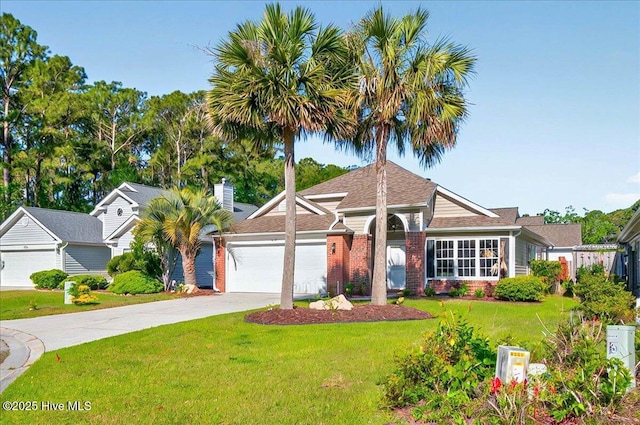 single story home with driveway, a chimney, a front yard, brick siding, and an attached garage