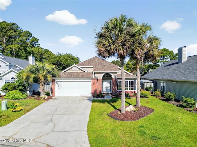 view of front of home featuring brick siding, a garage, a front lawn, and driveway