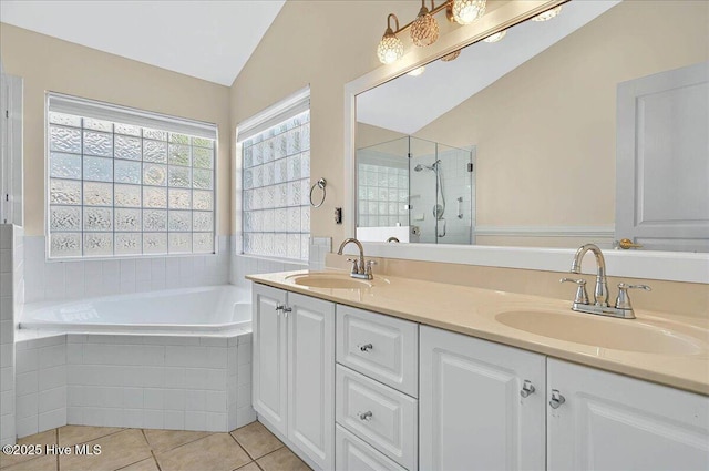 bathroom with a sink, a shower stall, a garden tub, and lofted ceiling