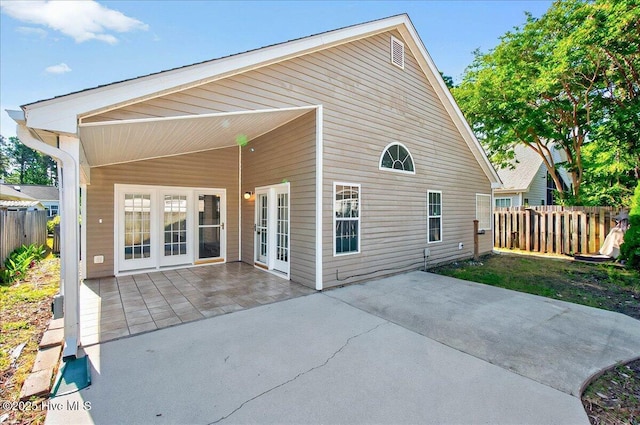 rear view of house featuring a patio and fence