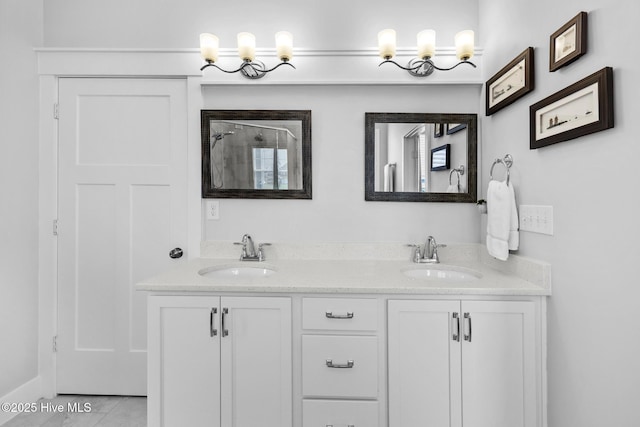 bathroom featuring a sink, tile patterned floors, an enclosed shower, and double vanity