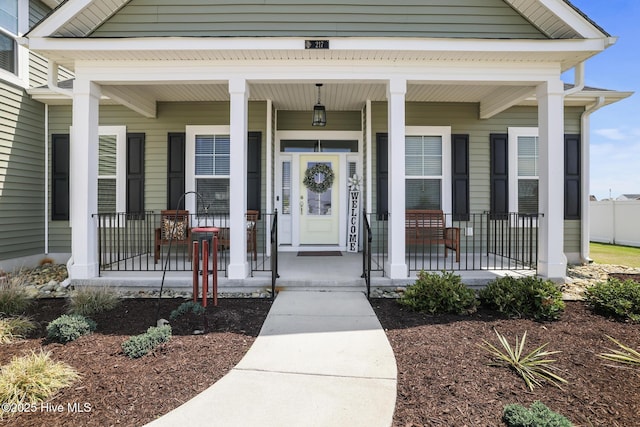 view of exterior entry featuring a porch