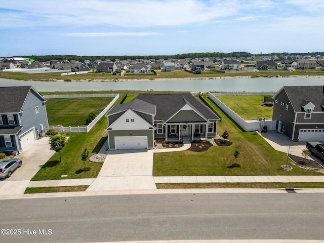 birds eye view of property featuring a water view and a residential view