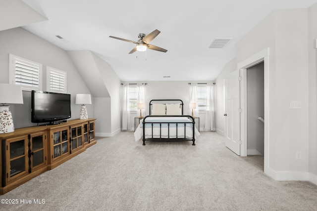 carpeted bedroom featuring baseboards, lofted ceiling, and visible vents