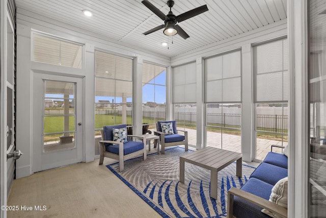 sunroom / solarium with ceiling fan, a wealth of natural light, and an outdoor hangout area