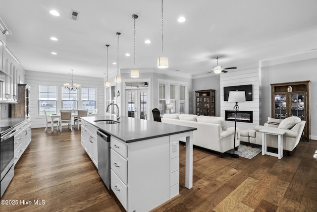 kitchen featuring a sink, ceiling fan with notable chandelier, stainless steel appliances, recessed lighting, and white cabinetry