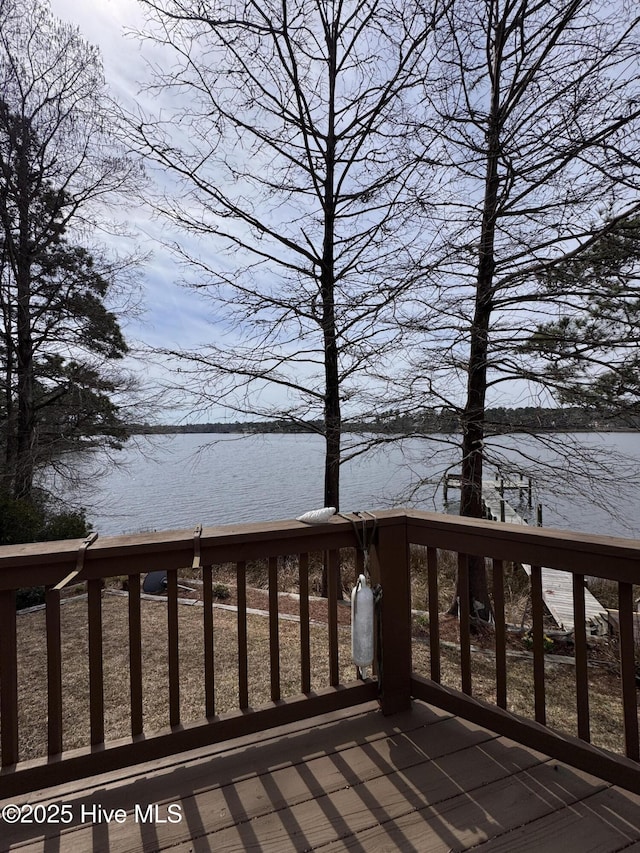 wooden terrace featuring a water view