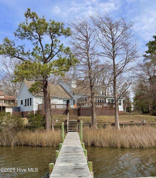 view of dock featuring stairs and a deck with water view