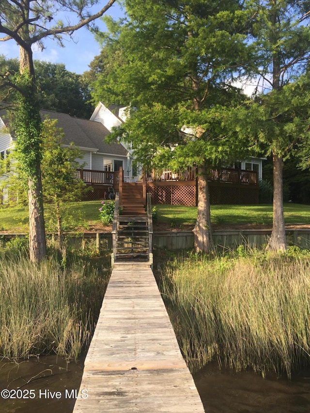 rear view of property featuring stairway and a deck