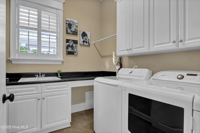 laundry area featuring independent washer and dryer, tile patterned floors, a sink, and cabinet space