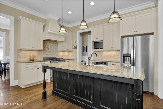 kitchen with a sink, appliances with stainless steel finishes, light stone countertops, and white cabinetry