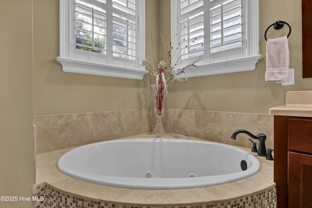 bathroom featuring vanity and a tub with jets