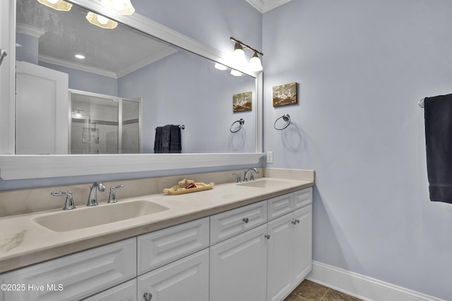 bathroom with baseboards, ornamental molding, a sink, and a stall shower