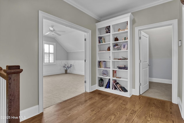 interior space featuring baseboards, a ceiling fan, lofted ceiling, and wood finished floors