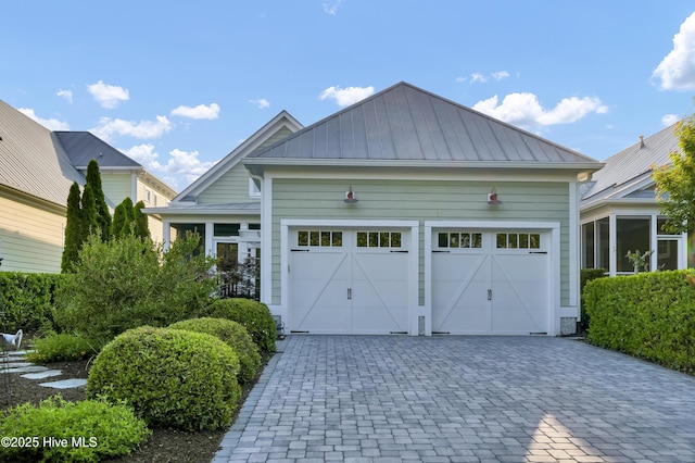 garage featuring decorative driveway