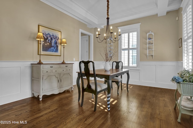 dining room with a decorative wall, an inviting chandelier, a wealth of natural light, and a wainscoted wall
