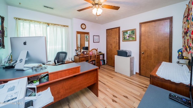 office featuring visible vents, a ceiling fan, and light wood-type flooring