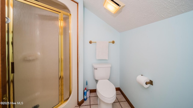 full bath with tile patterned flooring, toilet, baseboards, a shower stall, and vaulted ceiling