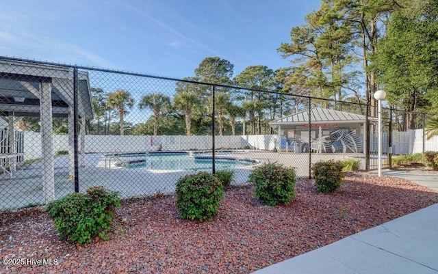 16 Myrtlewood Dr SW, Calabash, NC 28467 - view of tennis court featuring fence, a gazebo, and a fenced in pool