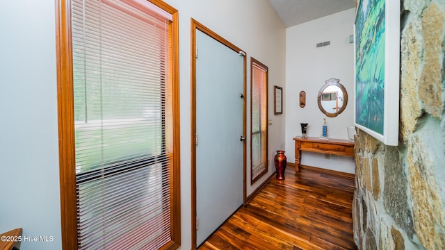 hall with dark wood-style flooring and visible vents