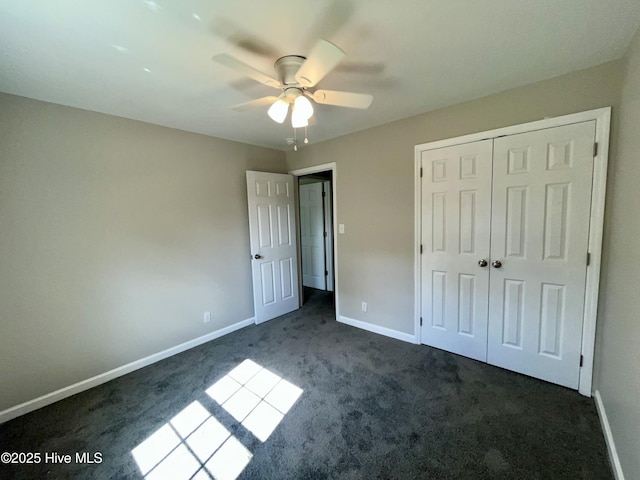 12321 Purcell Rd, Laurinburg, NC 28352 - unfurnished bedroom featuring a ceiling fan, baseboards, dark carpet, and a closet