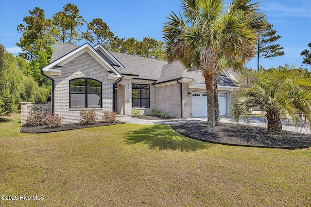 ranch-style home with brick siding, an attached garage, a front yard, and roof with shingles
