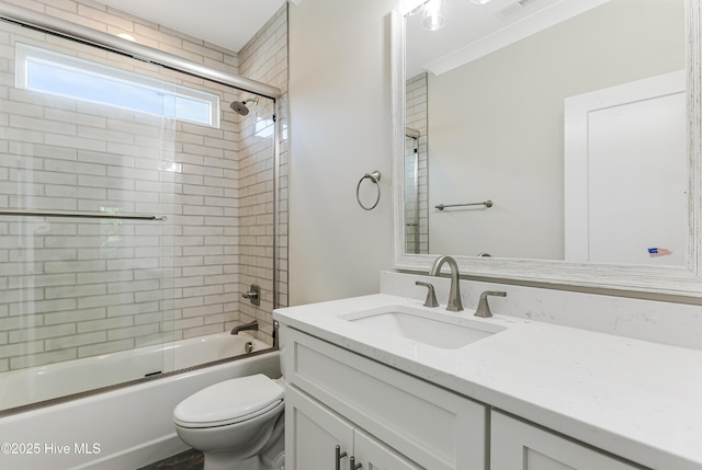 full bathroom with toilet, visible vents, shower / bath combination with glass door, and vanity