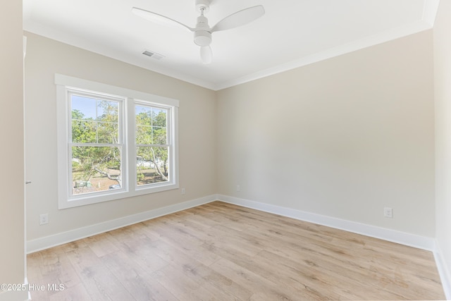 empty room featuring crown molding, ceiling fan, baseboards, light wood-type flooring, and visible vents