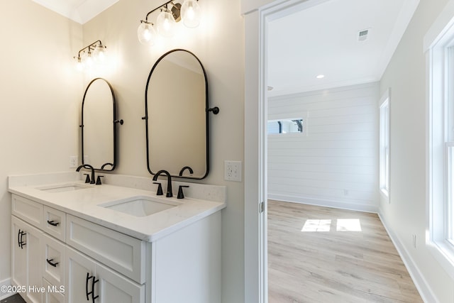 229 NE 34th St, Oak Island, NC 28465 - full bathroom featuring double vanity and wood finished floors