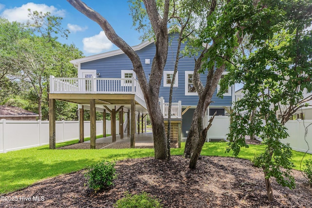 229 NE 34th St, Oak Island, NC 28465 - rear view of house featuring a wooden deck, a fenced backyard, and stairs