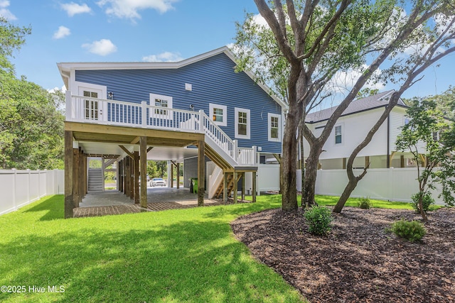 229 NE 34th St, Oak Island, NC 28465 - rear view of property featuring stairs, a wooden deck, and a carport