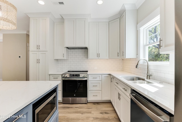 kitchen featuring stainless steel appliances, visible vents, a sink, and recessed lighting