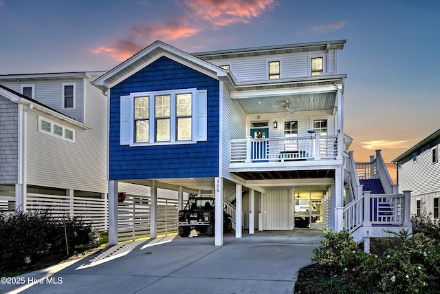 305 Ivy Ln, Carolina Beach, NC 28428 - view of front of property featuring a carport, stairs, driveway, and covered porch