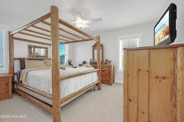 305 Ivy Ln, Carolina Beach, NC 28428 - bedroom featuring light colored carpet, multiple windows, and a ceiling fan