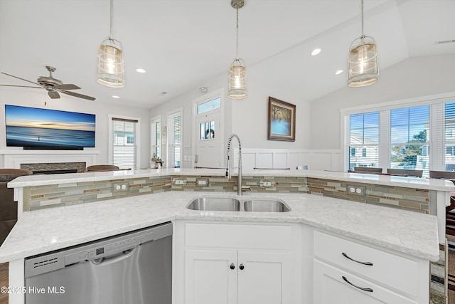 305 Ivy Ln, Carolina Beach, NC 28428 - kitchen featuring stainless steel dishwasher, a sink, open floor plan, decorative backsplash, and lofted ceiling