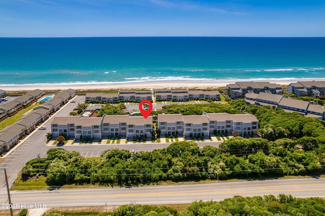 birds eye view of property featuring a view of the beach and a water view