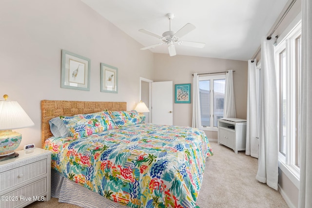 bedroom featuring a ceiling fan, vaulted ceiling, and light carpet