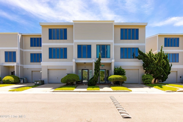 multi unit property with driveway and a garage