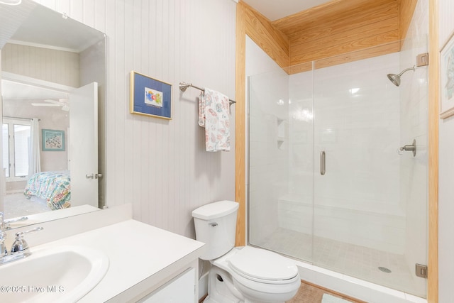 ensuite bathroom featuring vanity, a shower stall, and toilet