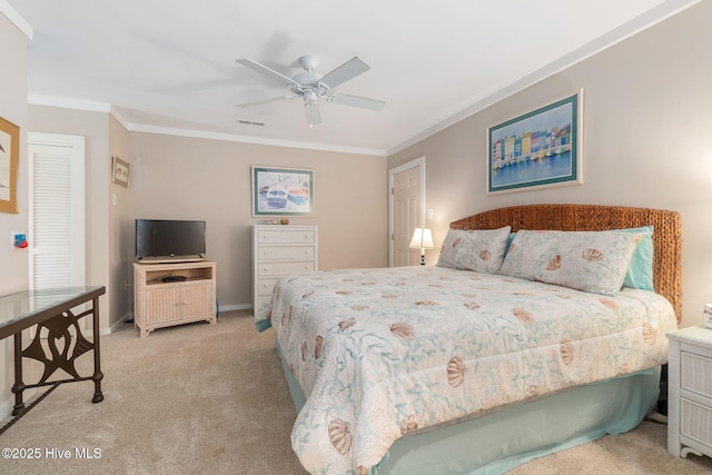 carpeted bedroom featuring crown molding, a ceiling fan, baseboards, and visible vents