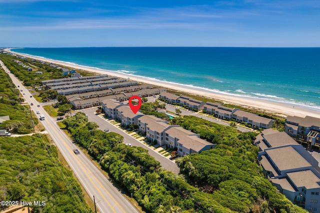 drone / aerial view with a beach view and a water view